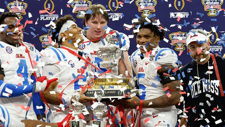 Jan 1, 2026; New Orleans, LA, USA; Mississippi Rebels quarterback Trinidad Chambliss (6) and running back Kewan Lacy (5) lift the trophy after the 2026 Sugar Bowl and quarterfinal game of the College Football Playoff against the Georgia Bulldogs at Caesars Superdome. Mandatory Credit: Amber Searls-Imagn Images Jan 1, 2026; New Orleans, LA, USA; Mississippi Rebels quarterback Trinidad Chambliss (6) and running back Kewan Lacy (5) lift the trophy after the 2026 Sugar Bowl and quarterfinal game of the College Football Playoff against the Georgia Bulldogs at Caesars Superdome. Mandatory Credit: Amber Searls-Imagn Images