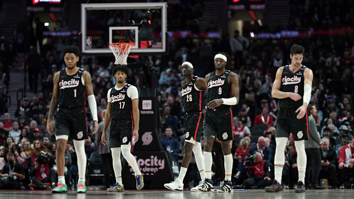 Dec 6, 2024; Portland, Oregon, USA; Portland Trail Blazers (from left to right) Anfernee Simons (1), Shaedon Sharpe (17), Duop Reath (26), Jerami Grant (9), and Deni Avdija (8) walk back to the court after a timeout during the first half against the Utah Jazz at Moda Center. Mandatory Credit: Soobum Im-Imagn Images