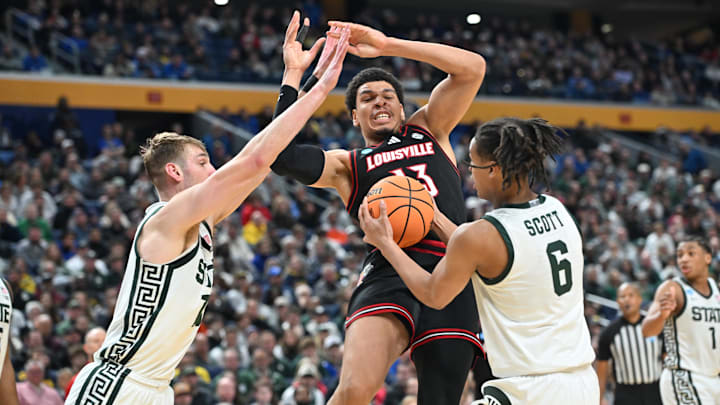 Mar 21, 2026; Buffalo, NY, USA; Michigan State Spartans forward Jordan Scott (6) holds the ball from Louisville Cardinals forward/center Sananda Fru (13) in the second half during a second round game of the men's 2026 NCAA Tournament at Keybank Center. Mandatory Credit: Mark Konezny-Imagn Images