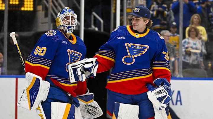 Mar 13, 2024; St. Louis, Missouri, USA;  St. Louis Blues goaltender Jordan Binnington (50) celebrates with goaltender Joel Hofer (30) after the Blues defeated the Los Angeles Kings at Enterprise Center. Mandatory Credit: Jeff Curry-Imagn Images