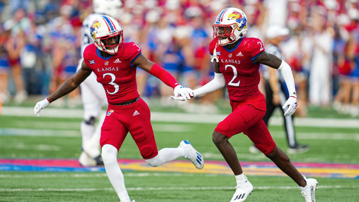 Sep 23, 2023; Lawrence, Kansas, USA; Kansas Jayhawks cornerback Cobee Bryant (2) celebrates with cornerback Mello Dotson (3) after an interception against the Brigham Young Cougars during the second half at David Booth Kansas Memorial Stadium. Mandatory Credit: Jay Biggerstaff-USA TODAY Sports Sep 23, 2023; Lawrence, Kansas, USA; Kansas Jayhawks cornerback Cobee Bryant (2) celebrates with cornerback Mello Dotson (3) after an interception against the Brigham Young Cougars during the second half at David Booth Kansas Memorial Stadium. Mandatory Credit: Jay Biggerstaff-USA TODAY Sports