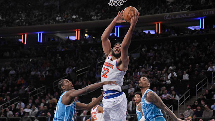 Dec 5, 2024; New York, New York, USA; New York Knicks center Karl-Anthony Towns (32) shoots the ball while being defended by Charlotte Hornets forward Moussa Diabate (14) and Charlotte Hornets guard DaQuan Jeffries (3) during the second half at Madison Square Garden. Mandatory Credit: John Jones-Imagn Images Dec 5, 2024; New York, New York, USA; New York Knicks center Karl-Anthony Towns (32) shoots the ball while being defended by Charlotte Hornets forward Moussa Diabate (14) and Charlotte Hornets guard DaQuan Jeffries (3) during the second half at Madison Square Garden. Mandatory Credit: John Jones-Imagn Images