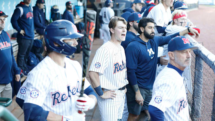 University of Mississippi baseball players watch their teammates from their dugout during a game