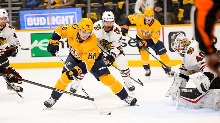 Jan 16, 2025; Nashville, Tennessee, USA;  Chicago Blackhawks goaltender Arvid Soderblom (40) blocks the shot of Nashville Predators left wing Zachary L'Heureux (68) during the first period at Bridgestone Arena. Mandatory Credit: Steve Roberts-Imagn Images
