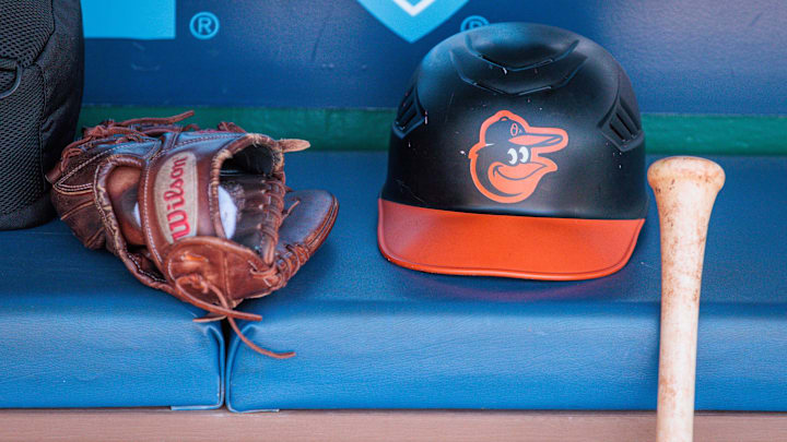 Apr 21, 2024; Kansas City, Missouri, USA; Baltimore Orioles hat and glove sits in the dugout during the ninth inning against the Kansas City Royals at Kauffman Stadium. Mandatory Credit: William Purnell-Imagn Images
