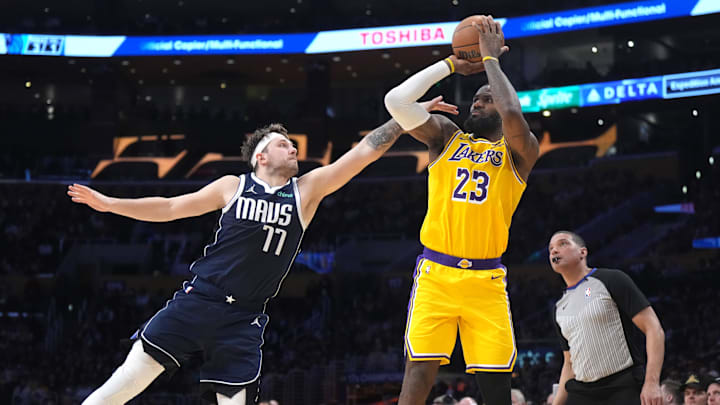 Jan 17, 2024; Los Angeles, California, USA; Los Angeles Lakers forward LeBron James (23) shoots the ball against Dallas Mavericks guard Luka Doncic (77) in the second half at Crypto.com Arena. Mandatory Credit: Kirby Lee-Imagn Images Jan 17, 2024; Los Angeles, California, USA; Los Angeles Lakers forward LeBron James (23) shoots the ball against Dallas Mavericks guard Luka Doncic (77) in the second half at Crypto.com Arena. Mandatory Credit: Kirby Lee-Imagn Images