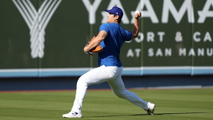 Sep 25, 2024; Los Angeles, California, USA; Los Angeles Dodgers designated hitter Shohei Ohtani throws before the game against the San Diego Padres at Dodger Stadium. Mandatory Credit: Kirby Lee-Imagn Images