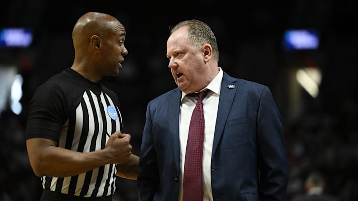 Mar 19, 2026; Portland, OR, USA; Wisconsin Badgers head coach Greg Gard talks with an official during the second half of a first round game of the men's 2026 NCAA Tournament against the High Point Panthers at Moda Center. Mandatory Credit: Troy Wayrynen-Imagn Images