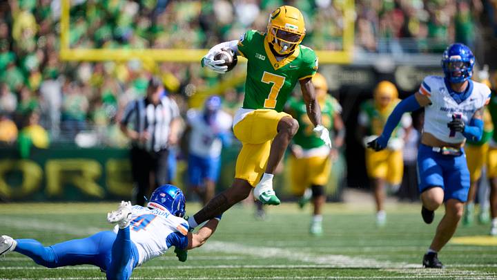 Oregon wide receiver Evan Stewart runs by Boise State safety Travis Anderson. Oregon wide receiver Evan Stewart runs by Boise State safety Travis Anderson.