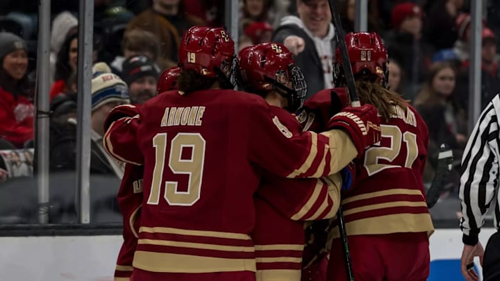 Jade Arnone, Maxim Tremblay and other Eagles celebrate goal against UNH.