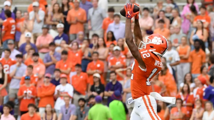 Clemson Tigers wide receiver Bryant Wesco Jr. (12) catches a pass while being defended by Troy Trojans safety David Daniel-Sisavanh (14) Saturday, Sept. 6, 2025 during the NCAA football game at Memorial Stadium in Clemson, South Carolina.