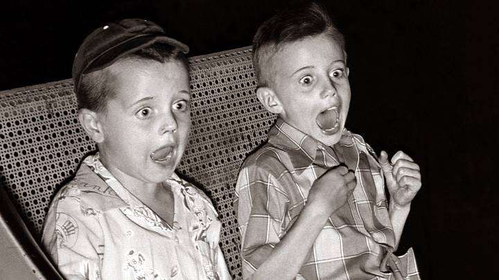 FunTwo young boys screaming as they take the Ghost Train ride at the funfair August 1954