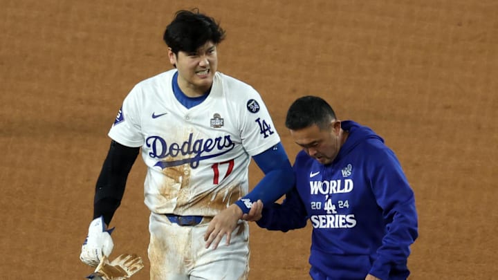 Oct 26, 2024; Los Angeles, California, USA; Los Angeles Dodgers designated hitter Shohei Ohtani (17) walks off the field after injuring his shoulder against the New York Yankees in the seventh inning for Game 2 of the 2024 MLB World Series at Dodger Stadium. Oct 26, 2024; Los Angeles, California, USA; Los Angeles Dodgers designated hitter Shohei Ohtani (17) walks off the field after injuring his shoulder against the New York Yankees in the seventh inning for Game 2 of the 2024 MLB World Series at Dodger Stadium.