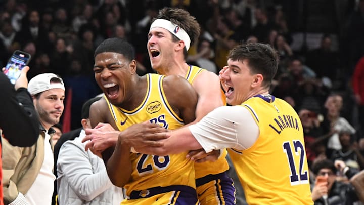 Dec 4, 2025; Toronto, Ontario, CAN; Los Angeles Lakers forward Rui Hachimura (28) celebrates with forward Jake LaRavia (12) and guard Austin Reaves (15) after scoring the game winning buzzer beating basket against the Toronto Raptos half at Scotiabank Arena. Mandatory Credit: Dan Hamilton-Imagn Images