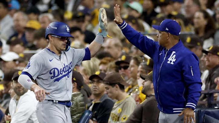 Oct 9, 2024; San Diego, California, USA; Los Angeles Dodgers third baseman Enrique Hernandez (8) celebrates with manager Dave Roberts (30) after scoring in the second inning against the San Diego Padres during game four of the NLDS for the 2024 MLB Playoffs at Petco Park. Mandatory Credit: David Frerker-Imagn Images