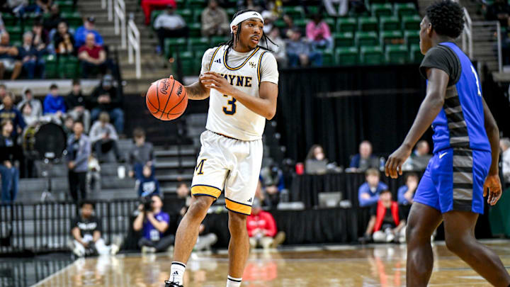 Wayne Memorial's Carlos Medlock Jr. moves the ball against Flint Carman-Ainsworth during the second quarter in the Division 1 state semifinal on Friday, March 14, 2025, at the Breslin Center in East Lansing.