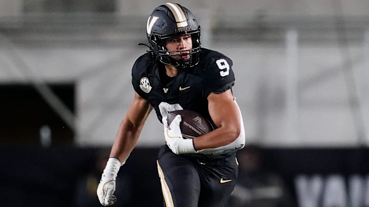 Vanderbilt tight end Eli Stowers (9) evades Ball State defensive back George Udo (10) during the fourth quarter at FirstBank Stadium in Nashville, Tenn., Saturday, Oct. 19, 2024.