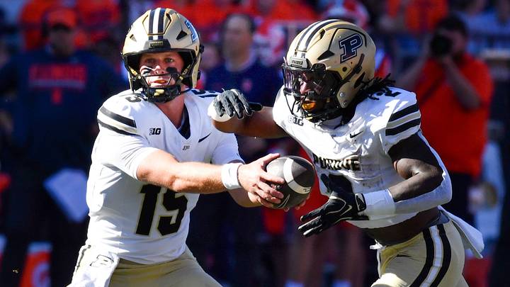 Purdue Boilermakers quarterback Ryan Browne (15) hands the ball to running back Fame Ijeboi (2). Purdue Boilermakers quarterback Ryan Browne (15) hands the ball to running back Fame Ijeboi (2).