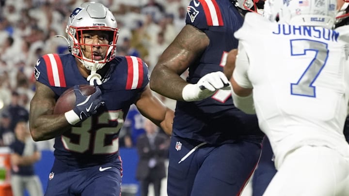 Oct 5, 2025; Orchard Park, New York, USA; New England Patriots running back Treveyon Henderson (32) rushes the ball against the Buffalo Bills during the first half at Highmark Stadium.