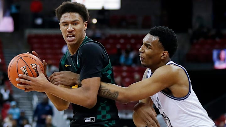 Freedom High School's Donovan Davis (24) is fouled by Milwaukee Academy of Science's Devin Brown (12) during the WIAA Division 3 state championship game on Saturday, March 22, 2025, at the Kohl Center in Madison, Wis. Milwaukee Academy of Science won the game, 57-54.