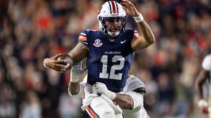 Auburn Tigers quarterback Ashton Daniels (12) runs the ball as Auburn Tigers take on Alabama Crimson Tide in the Iron Bowl at Jordan-Hare Stadium in Auburn, Ala. on Saturday, Nov. 29, 2025. Alabama Crimson Tide leads Auburn Tigers 17-6. Auburn Tigers quarterback Ashton Daniels (12) runs the ball as Auburn Tigers take on Alabama Crimson Tide in the Iron Bowl at Jordan-Hare Stadium in Auburn, Ala. on Saturday, Nov. 29, 2025. Alabama Crimson Tide leads Auburn Tigers 17-6.