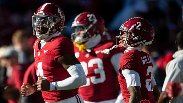 Alabama Crimson Tide quarterback Jalen Milroe and wide receiver Ryan Williams take the field during warm ups.