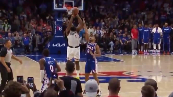 Two referees watch as Quentin Grimes hits James Harden’s elbow on a last-second shot in Philadelphia. 