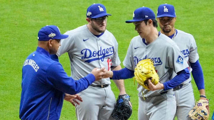 Oct 13, 2025; Milwaukee, Wisconsin, USA; Los Angeles Dodgers manager Dave Roberts (30) takes the ball from pitcher Roki Sasaki (11) in the ninth inning during game one of the NLCS round against the Milwaukee Brewers for the 2025 MLB playoffs at American Family Field. Mandatory Credit: Michael McLoone-Imagn Images Oct 13, 2025; Milwaukee, Wisconsin, USA; Los Angeles Dodgers manager Dave Roberts (30) takes the ball from pitcher Roki Sasaki (11) in the ninth inning during game one of the NLCS round against the Milwaukee Brewers for the 2025 MLB playoffs at American Family Field. Mandatory Credit: Michael McLoone-Imagn Images
