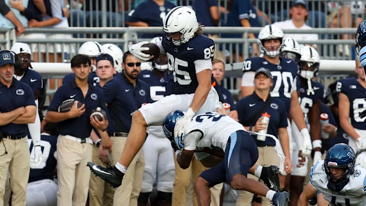 Penn State football tight end Luke Reynolds (85) leaps over  Villanova Wildcats defensive back Damill Bostic Jr.