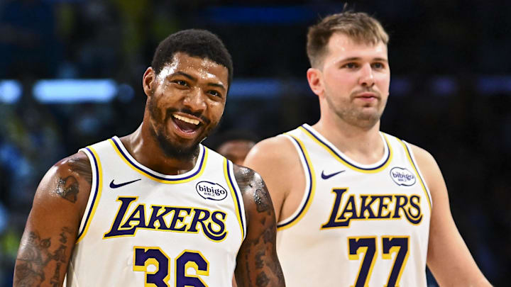 Nov 2, 2025; Los Angeles, California, USA; Los Angeles Lakers guard Marcus Smart (36) reacts with Los Angeles Lakers guard Luka Doncic (77) during a time out against the Miami Heat during the second half at Crypto.com Arena. Mandatory Credit: Jonathan Hui-Imagn Images