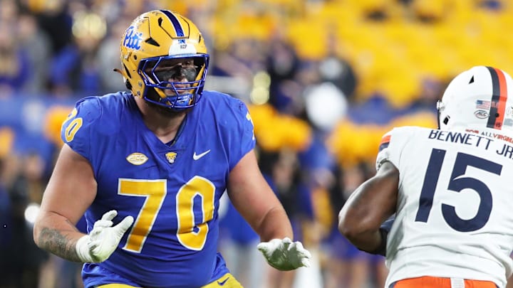 Nov 9, 2024; Pittsburgh, Pennsylvania, USA;  Pittsburgh Panthers offensive lineman Ryan Baer (70) blocks at the line of scrimmage against Virginia Cavaliers defensive end Chico Bennett Jr. (15) during the second quarter at Acrisure Stadium. Mandatory Credit: Charles LeClaire-Imagn Images