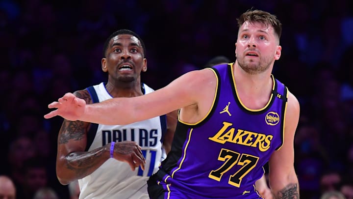 Feb 25, 2025; Los Angeles, California, USA; Los Angeles Lakers guard Luka Doncic (77) and Dallas Mavericks guard Kyrie Irving (11) attempt to gain control during the first quarter at Crypto.com Arena. Mandatory Credit: Gary A. Vasquez-Imagn Images