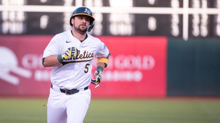 May 21, 2024; Oakland, California, USA; Oakland Athletics designated hitter J.D. Davis (5) rounds the bases after hitting a home run against the Colorado Rockies during the third inning at Oakland-Alameda County Coliseum. 