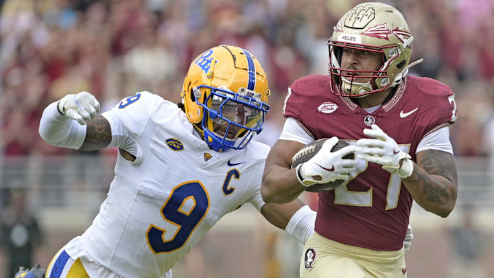 Oct 11, 2025; Tallahassee, Florida, USA; Florida State Seminoles running back Gavin Sawchuk (27) runs the ball past Pittsburgh Panthers linebacker Kyle Louis (9) during the first half at Doak S. Campbell Stadium. Mandatory Credit: Melina Myers-Imagn Images