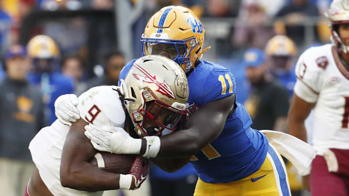 Nov 4, 2023; Pittsburgh, Pennsylvania, USA; Pittsburgh Panthers linebacker Bangally Kamara (11) tackles Florida State Seminoles running back Lawrance Toafili (9) in the backfield during the second quarter at Acrisure Stadium. Mandatory Credit: Charles LeClaire-Imagn Images Nov 4, 2023; Pittsburgh, Pennsylvania, USA; Pittsburgh Panthers linebacker Bangally Kamara (11) tackles Florida State Seminoles running back Lawrance Toafili (9) in the backfield during the second quarter at Acrisure Stadium. Mandatory Credit: Charles LeClaire-Imagn Images