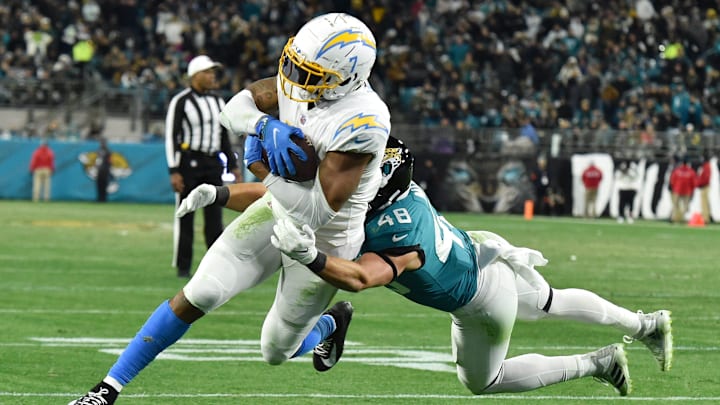 Chargers tight end Gerald Everett (7) eludes Jacksonville Jaguars linebacker Chad Muma (48) as he