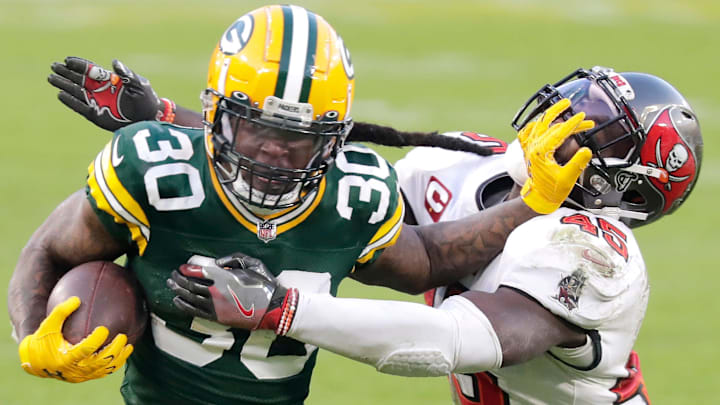 Green Bay Packers running back Jamaal Williams (30) rushes against the defense of Tampa Bay Buccaneers inside linebacker Devin White (45) during the NFC Championship game on Sunday, January 24, 2021, at Lambeau Field in Green Bay, Wis.Wm. Glasheen USA TODAY NETWORK-Wisconsin

Apc Packers Vs Bucs Nfc Champ 2327 012421 Wag