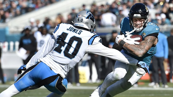 Jacksonville Jaguars tight end Evan Engram (17) tries to avoid Carolina Panthers linebacker Deion
