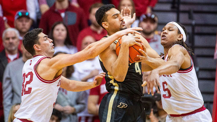 Purdue's Trey Kaufman-Renn (4) is tied up by Indiana's Malik Reneau (5) and Trey Galloway (32) 