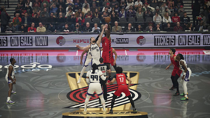 Nov 29, 2024; Portland, Oregon, USA; Sacramento Kings forward Domantas Sabonis (11) and Portland Trail Blazers center Deandre Ayton (2) leap for control of the ball during a game at Moda Center. Mandatory Credit: Troy Wayrynen-Imagn Images
