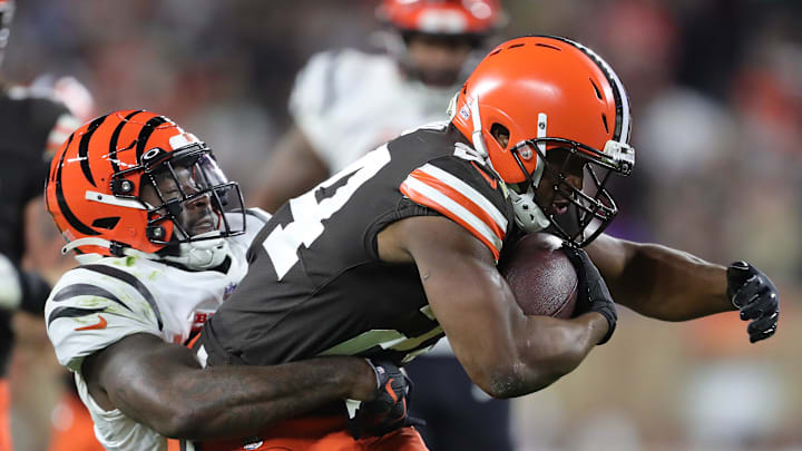 Browns running back Nick Chubb is brought down by Bengals linebacker Germaine Pratt during a game in 2022. 