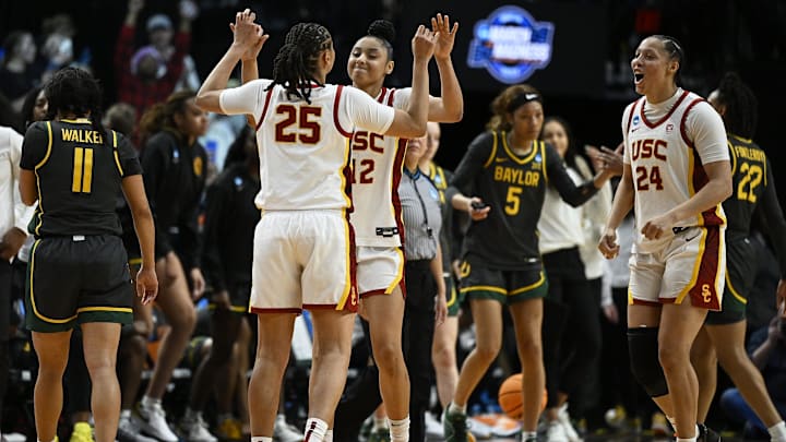 Mar 30, 2024; Portland, OR, USA; USC Trojans guard JuJu Watkins (12) celebrates with guard McKenzie Forbes (25) and forward Kaitlyn Davis (24) after a game against the Baylor Lady Bears in the semifinals of the Portland Regional of the 2024 NCAA Tournament at the Moda Center. Mandatory Credit: Troy Wayrynen-Imagn Images