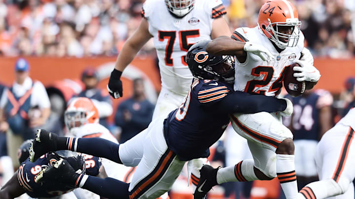 Former Bears defensive lineman Angelo Blackson tries to wrap up Browns back Nick Chubb, who remains a free agent.