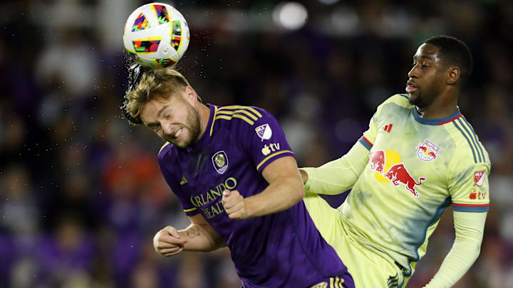 Nov 30, 2024; Orlando, Florida, USA; New York Red Bulls defender Andres Reyes (4) is called for a high kick against Orlando City forward Duncan McGuire (13) during the second half in the 2024 MLS Cup Eastern Conference Final match at Inter&Co Stadium. Mandatory Credit: Morgan Tencza-Imagn Images
