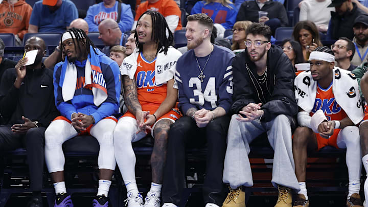 Jan 16, 2025; Oklahoma City, Oklahoma, USA; Oklahoma City Thunder guard Luguentz Dort (5), forward Jaylin Williams (6), center Isaiah Hartenstein (55), forward Chet Holmgren (7) and guard Shai Gilgeous-Alexander (2) watch as their team plays against the Cleveland Cavaliers during the fourth quarter at Paycom Center. Mandatory Credit: Alonzo Adams-Imagn Images