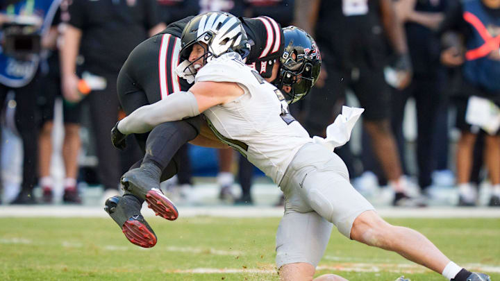 Oregon defensive back Dillon Thieneman, right, brings down Texas Tech quarterback Behren Morton