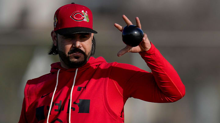 Cincinnati Reds infielder Eugenio Suarez (28) loosens up with a weighted ball at the Cincinnati Reds player development complex in Goodyear, Ariz., on Thursday, Feb. 12, 2026.