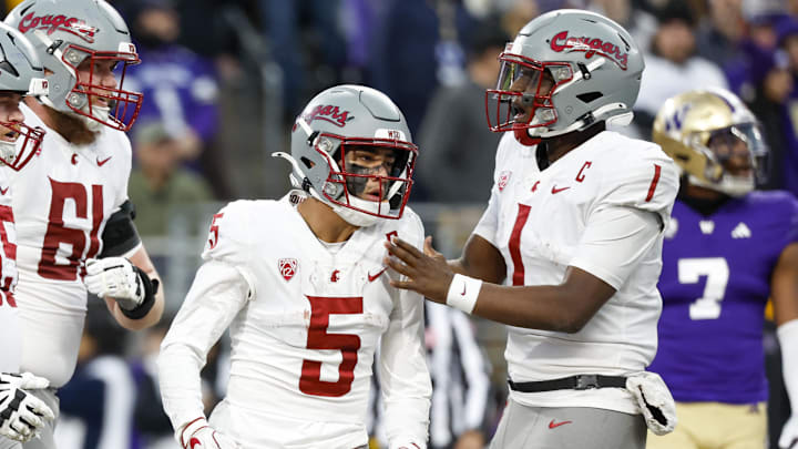 Nov 25, 2023; Seattle, Washington, USA; Washington State Cougars quarterback Cameron Ward (1) and wide receiver Lincoln Victor (5) celebrate following a touchdown against the Washington Huskies during the fourth quarter at Alaska Airlines Field at Husky Stadium. Mandatory Credit: Joe Nicholson-USA TODAY Sports
