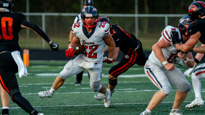 Grady Kinsey (22) of the Indian Valley Braves looks to pick up yardage in a week 1 game against Green, Aug. 22, 2025, at Green Memorial Stadium, in Uniontown, OH. Grady Kinsey (22) of the Indian Valley Braves looks to pick up yardage in a week 1 game against Green, Aug. 22, 2025, at Green Memorial Stadium, in Uniontown, OH.