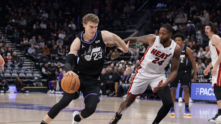 Jan 9, 2025; Salt Lake City, Utah, USA;  Utah Jazz forward Lauri Markkanen (23) dribbles the ball past Miami Heat forward Haywood Highsmith (24) during the second half at Delta Center. Mandatory Credit: Chris Nicoll-Imagn Images